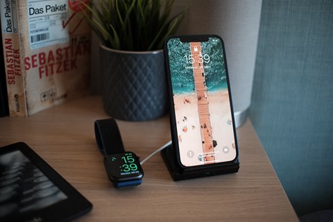 an iphone with a remote control on a desk