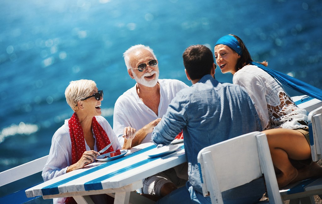 a group of people sitting around a table on a boat