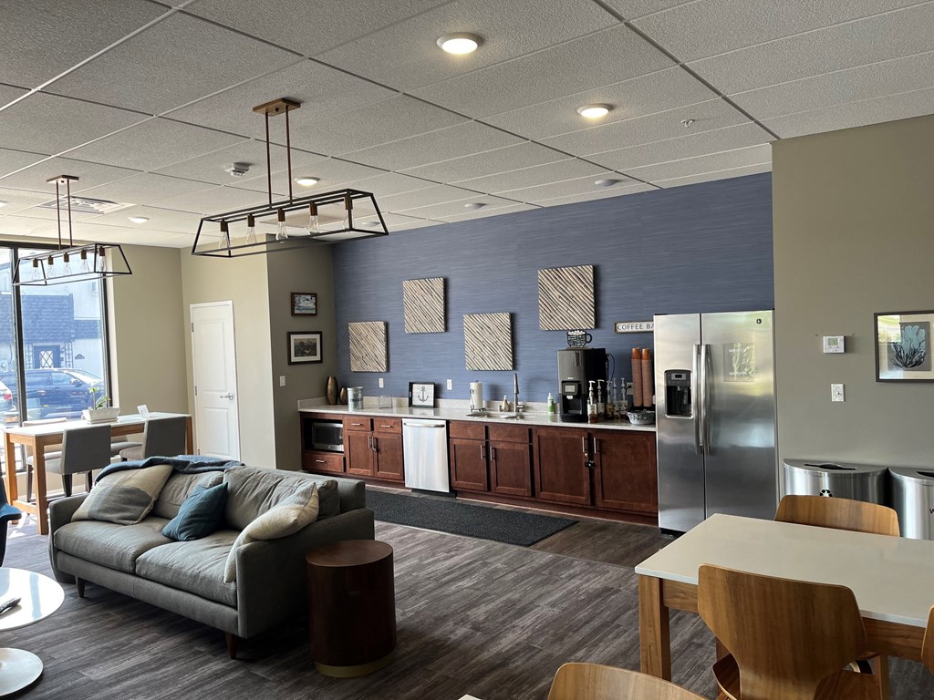 a kitchen and living room with a couch and a table