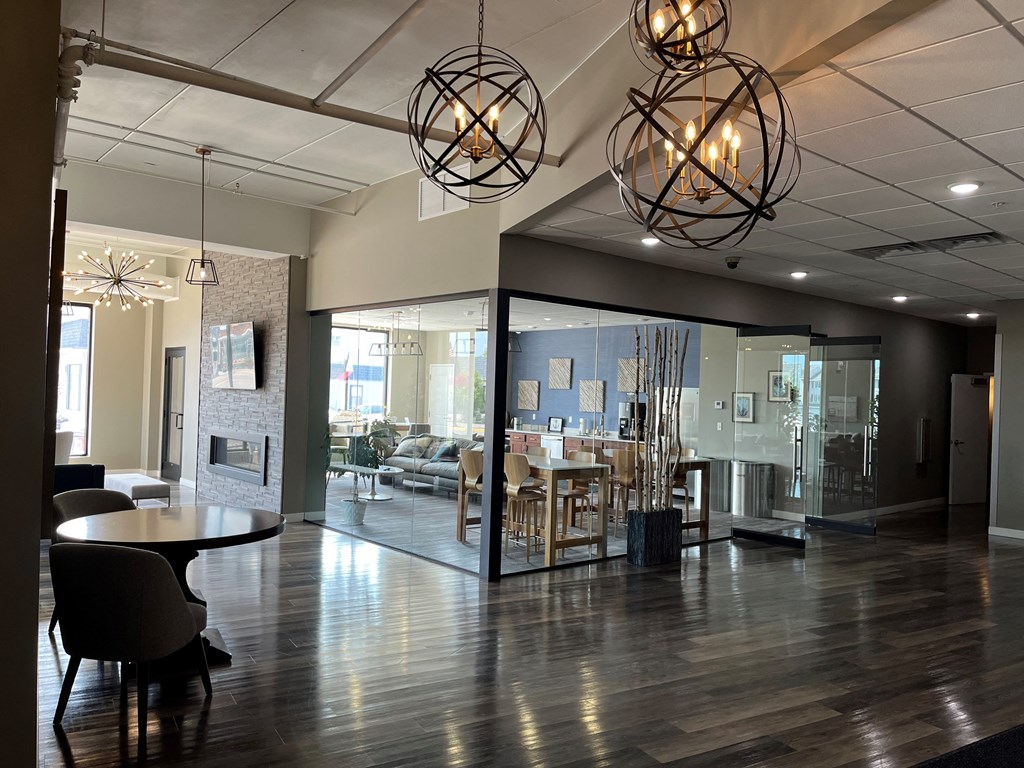 a large lobby with a table and chairs and lights
