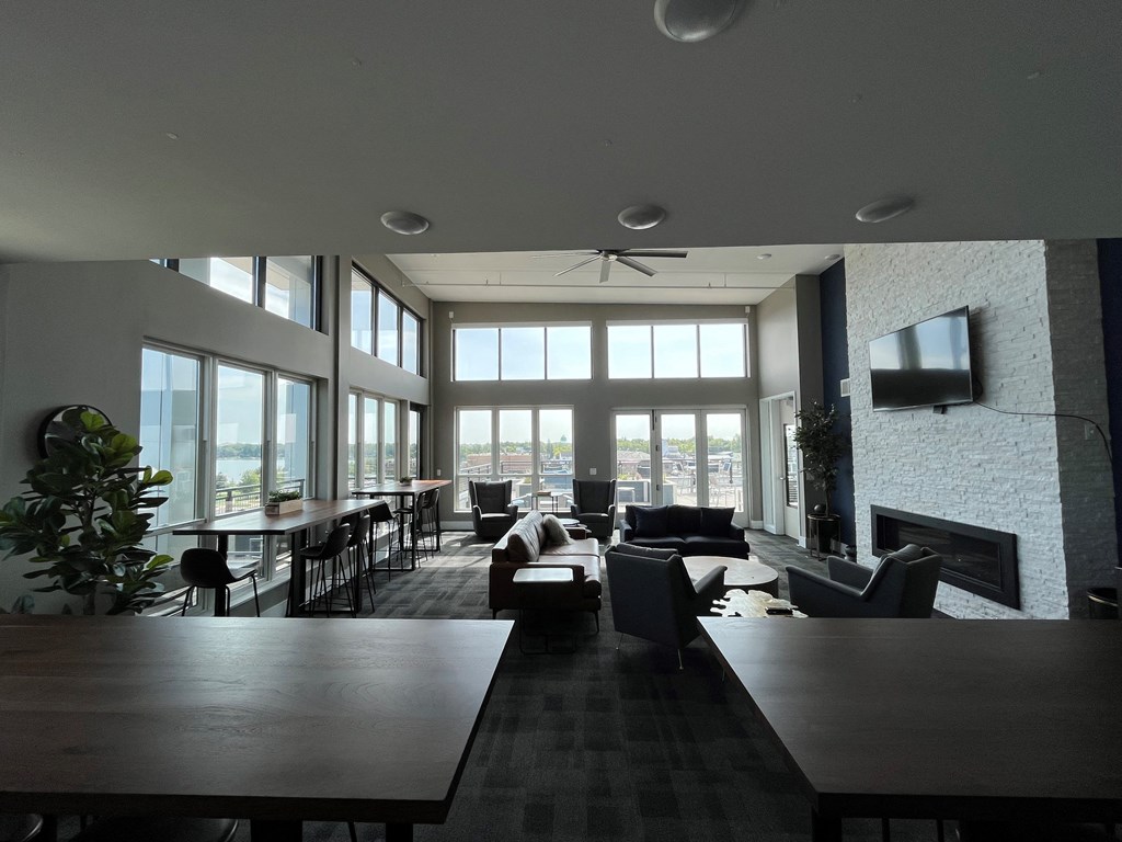 a large living room with lots of windows and furniture