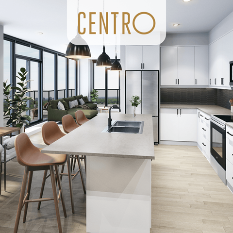 a kitchen with white cabinets and a large center island with chairs