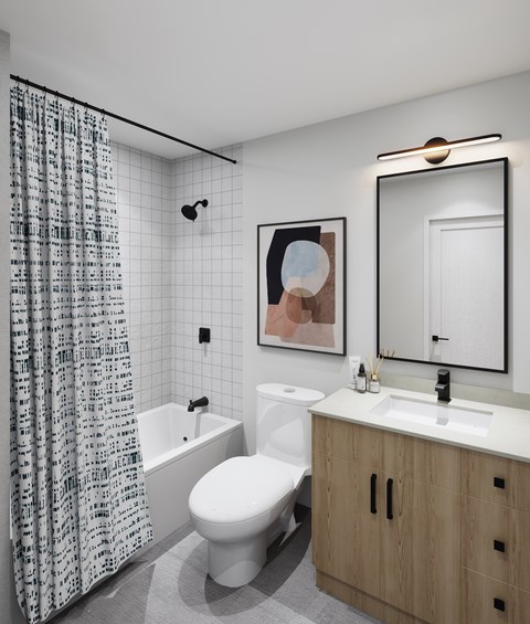 A bathroom with a white toilet, a white sink, a white bathtub, and a wooden cabinet.
