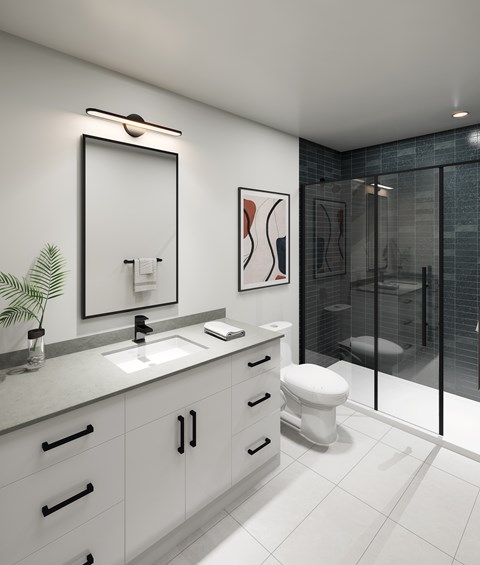 A modern bathroom with a glass shower stall and a white toilet.