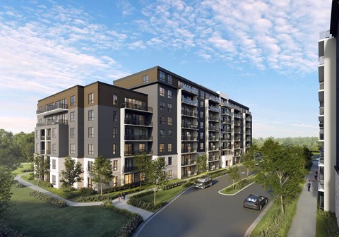 A modern apartment building with a curved design is shown in the image.