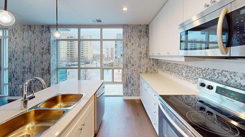 A modern kitchen with a stainless steel stove and a double sink.