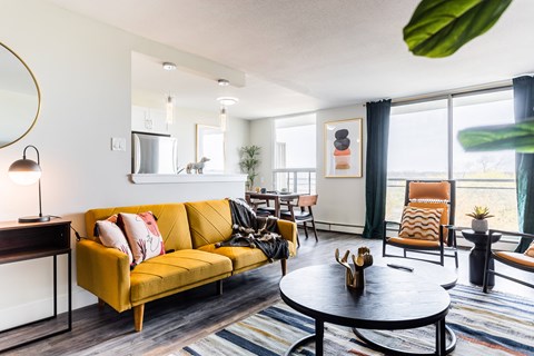 a living room with a yellow couch and a table