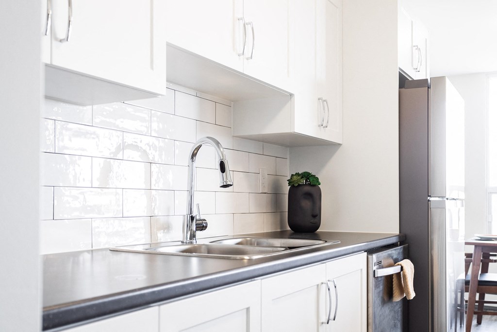 a kitchen with white cabinets and a sink