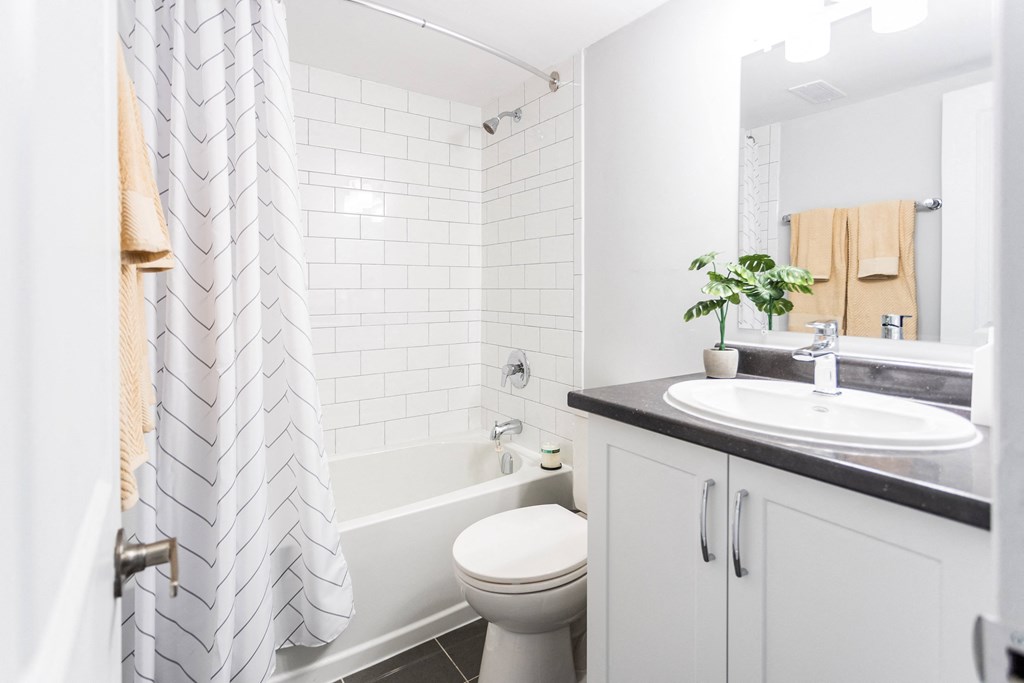 a white bathroom with a sink toilet and tub