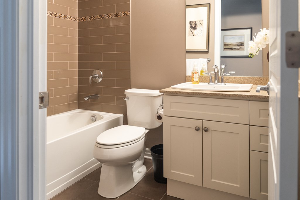 a bathroom with a toilet and a tub and a sink