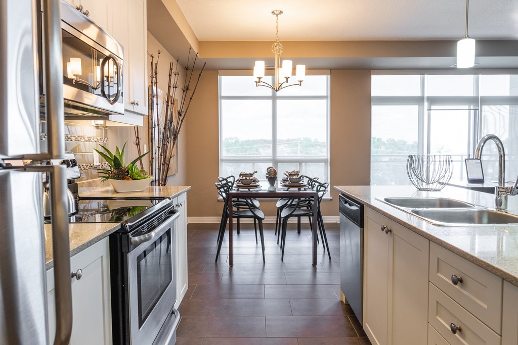 a kitchen with a dining table and a large window