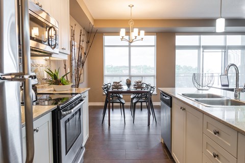 a kitchen with a dining table and a large window