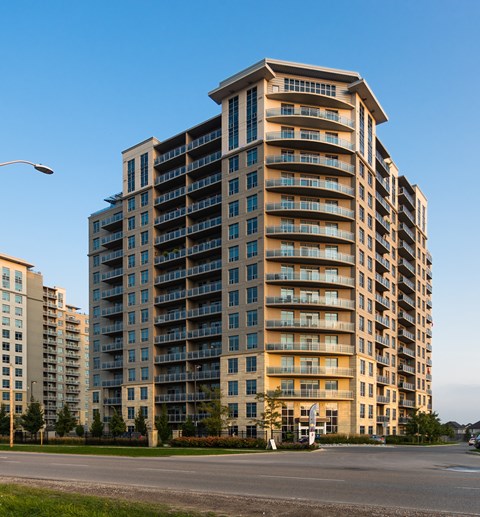 A large apartment building with balconies on each floor.