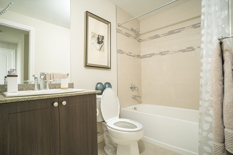 a bathroom with a toilet and a tub and a sink