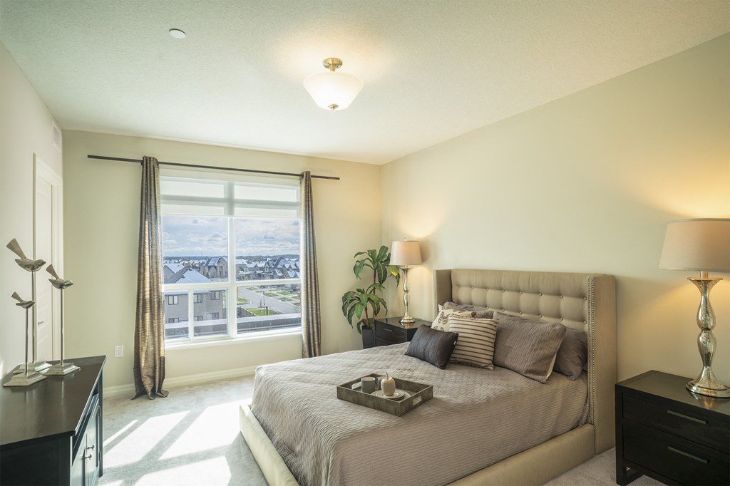 a bedroom with a large bed and a window