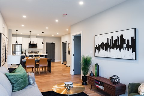 a living room and dining room with a couch and a table in a house