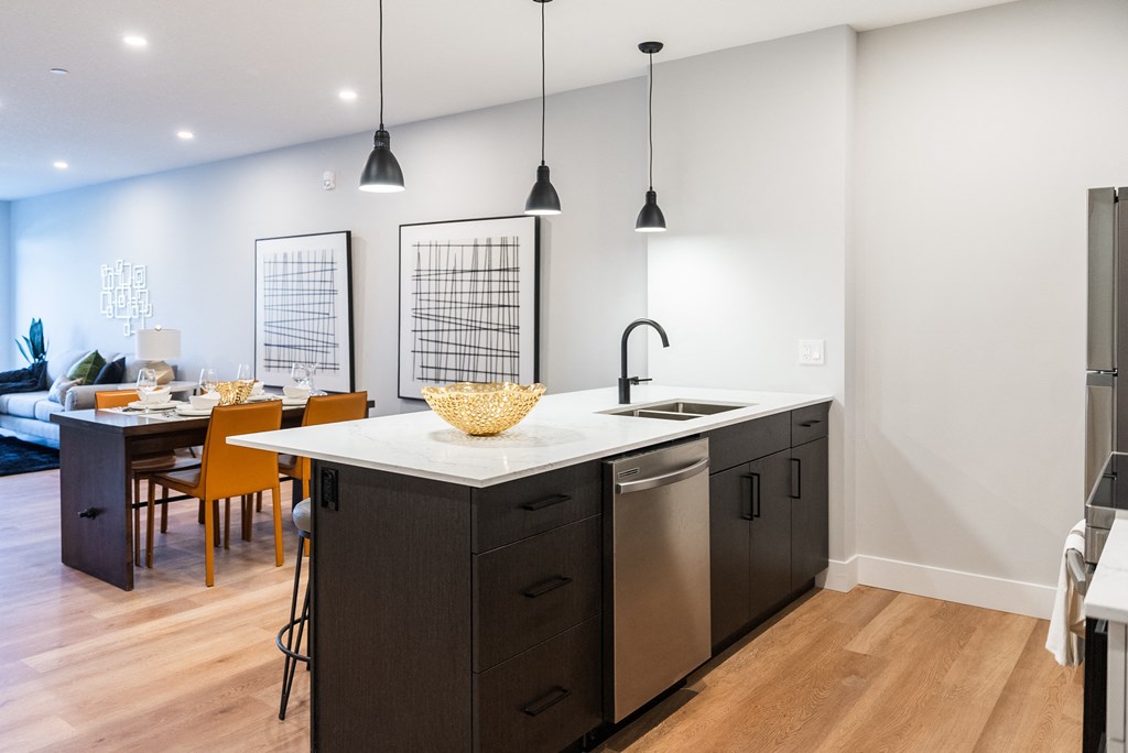 a kitchen with an island and a dining room with a table