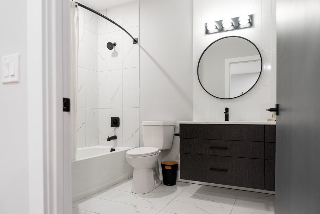 a bathroom with a toilet and a sink and a bath tub