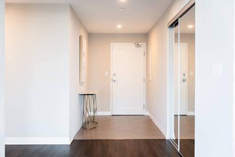 A white door is in the middle of a hallway.