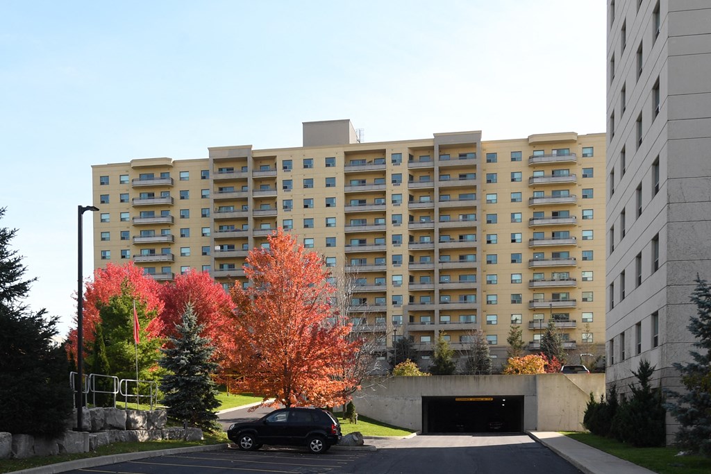 a car is parked in front of an apartment building