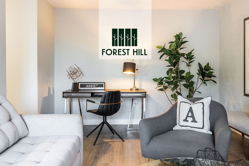 a living room with a couch and a chair and a desk