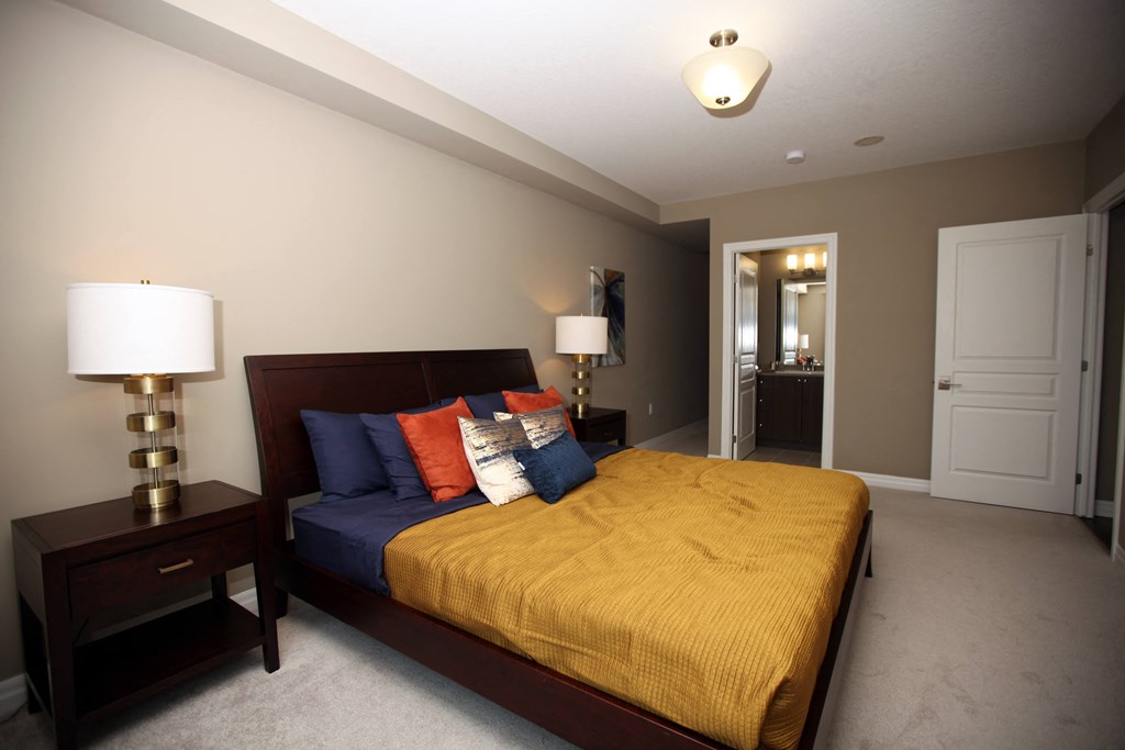 a bedroom with a large bed and two lamps