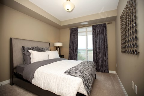 a large bedroom with a bed and a window