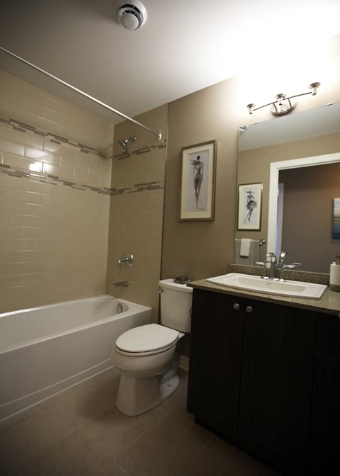 a small bathroom with a sink toilet and tub