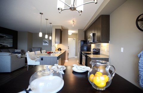 a dining room table with lemons in front of a kitchen