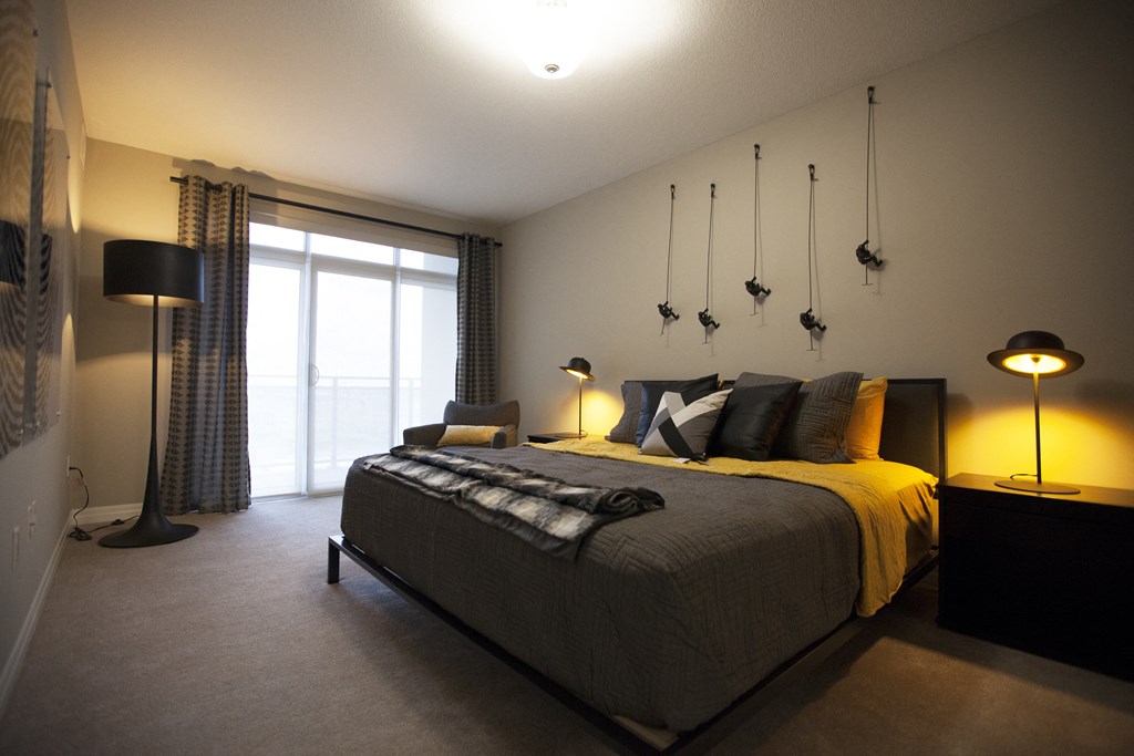 a bedroom with a large bed and a window