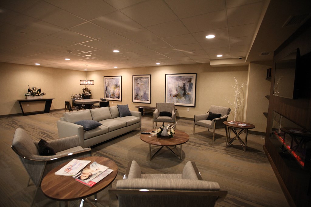 a living room with couches and chairs and a fireplace