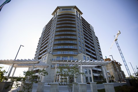 A large building with a crane in front of it.