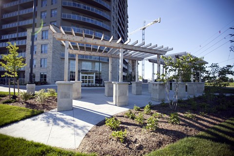 a covered area in front of a building with a crane