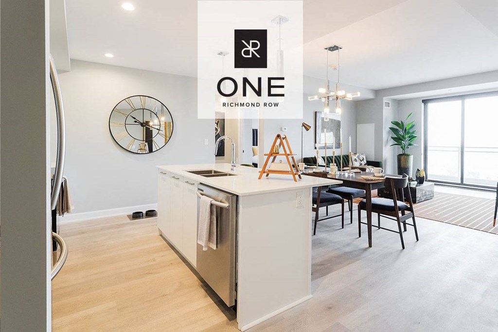 an open kitchen and dining room with a clock on the wall
