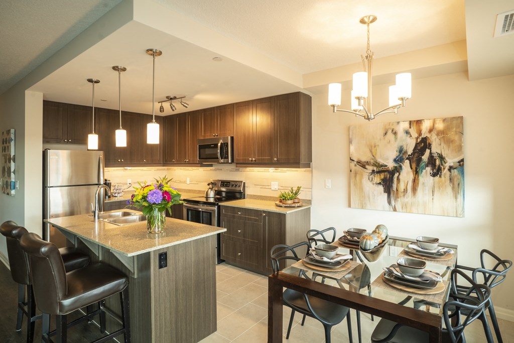 a kitchen and dining room with a table and chairs