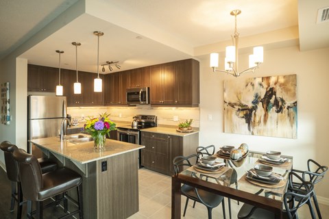 a kitchen and dining room with a table and chairs