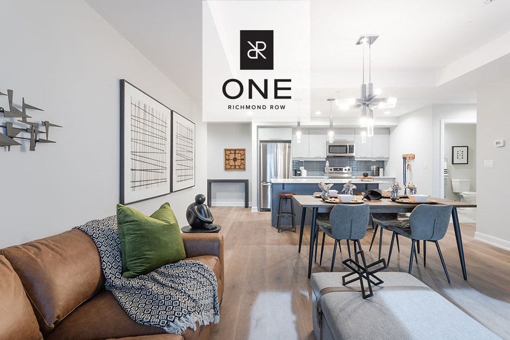 a living room with a couch and a table with chairs