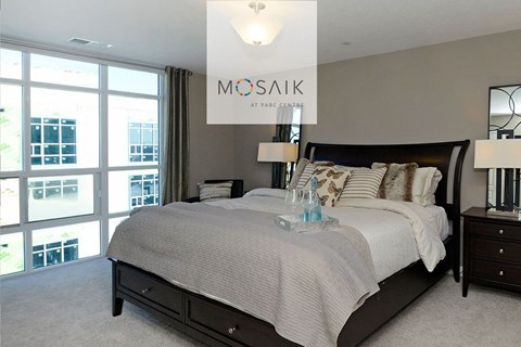 a bedroom with a bed and a large window