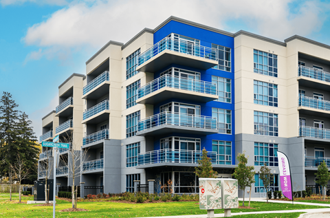 A large apartment building with balconies and multiple floors.