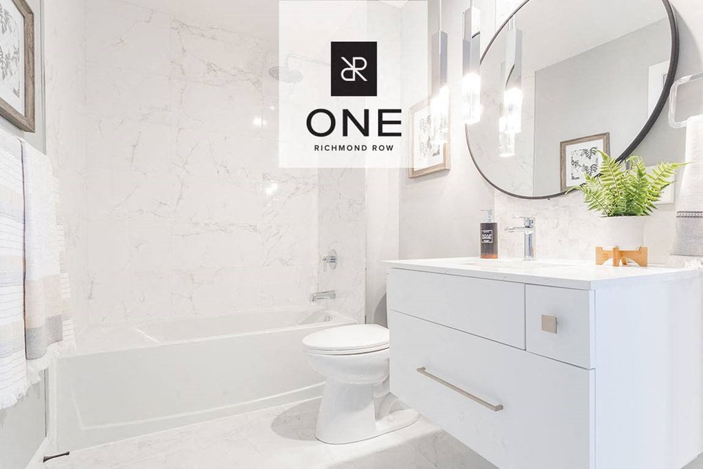 a white bathroom with a sink and a toilet
