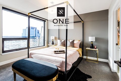 a bedroom with a bed and a large window