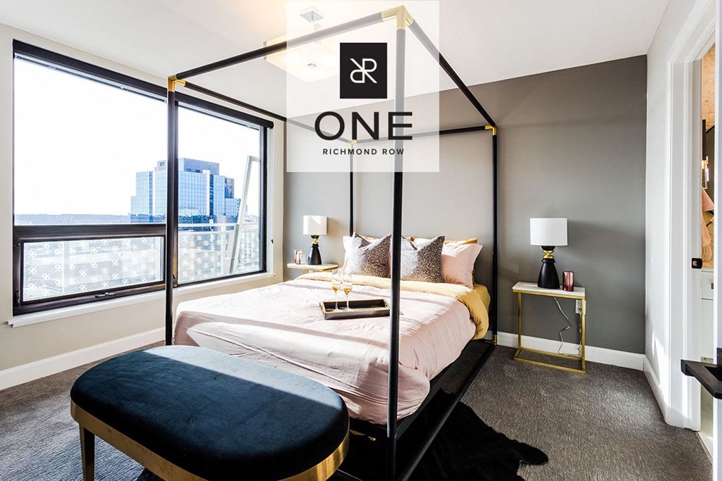 a bedroom with a bed and a large window