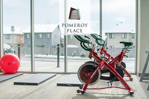 a red bike parked in a gym in front of a window