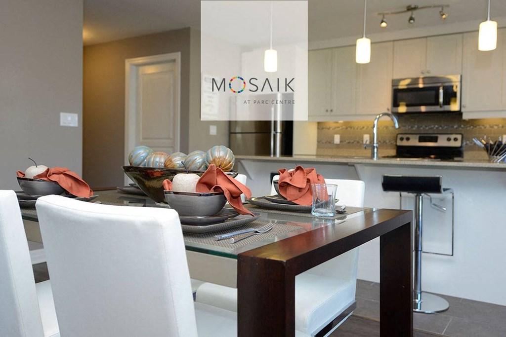 a kitchen and dining area with a table and chairs