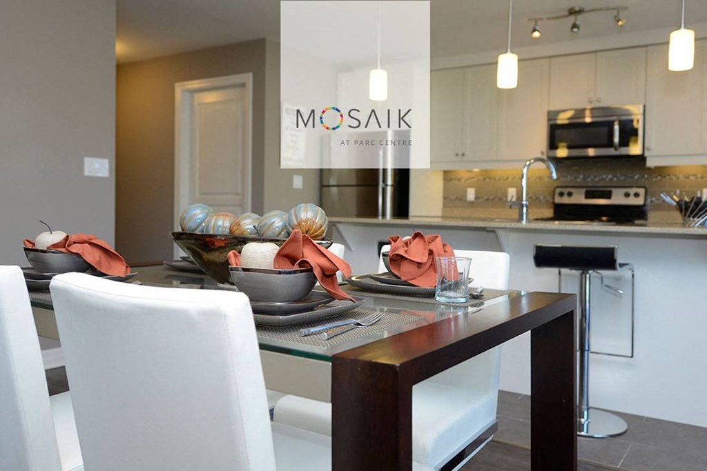a kitchen and dining area with a table and chairs