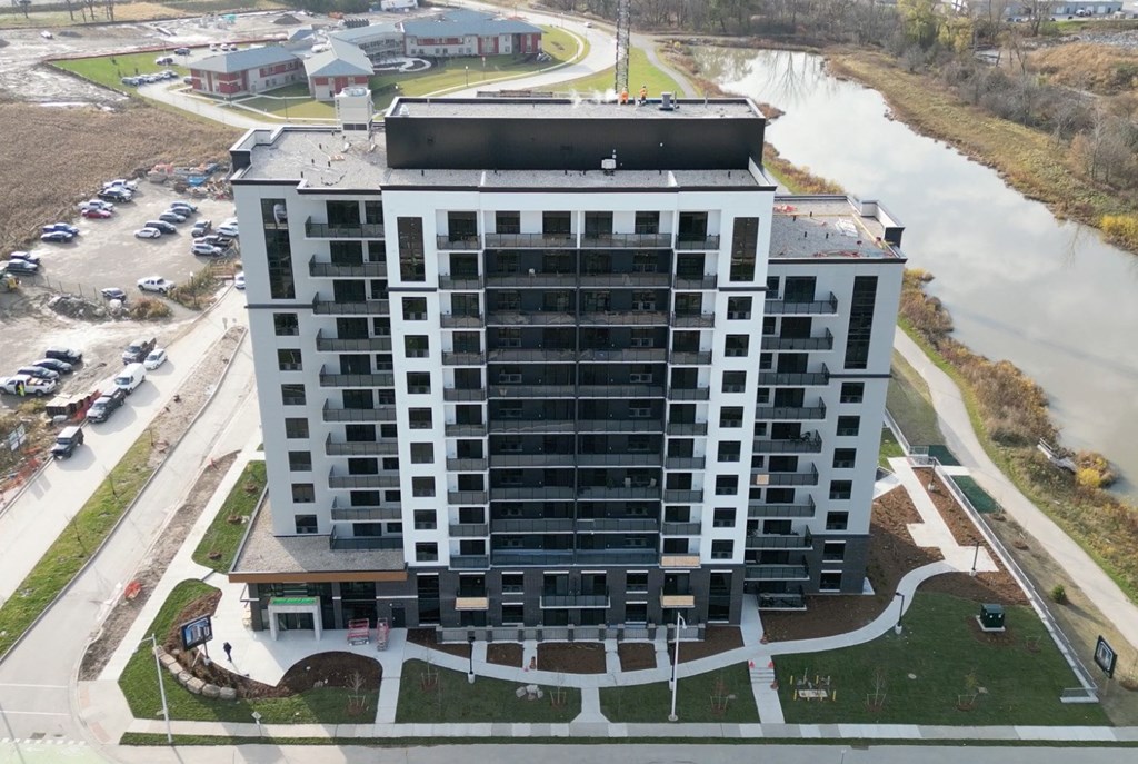 an aerial view of a building next to a river