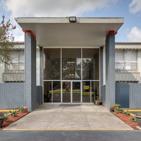 a photo of the front of a building with a large glass door
