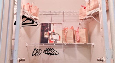 a closet with some clothes and shoes and bags