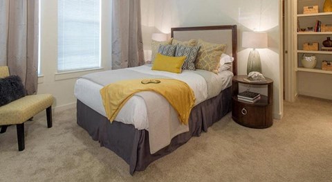 a bedroom with a bed and a chair