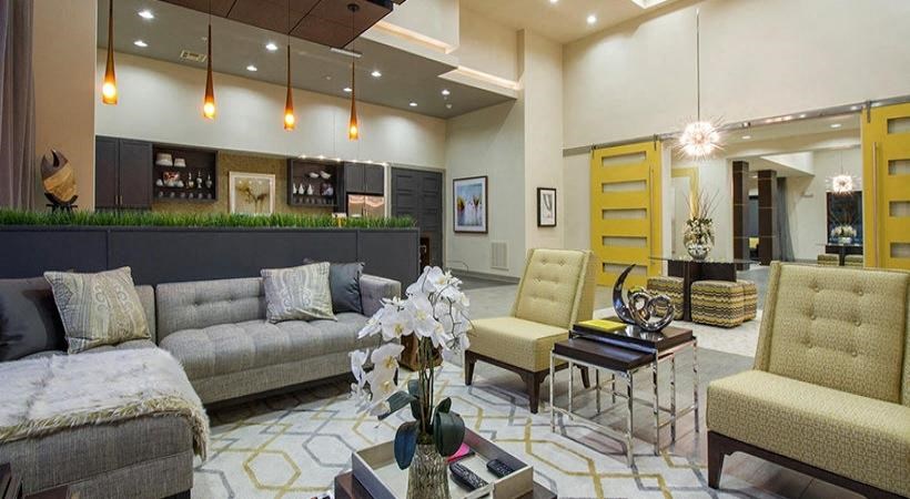 a living room with a couch and chairs and a table